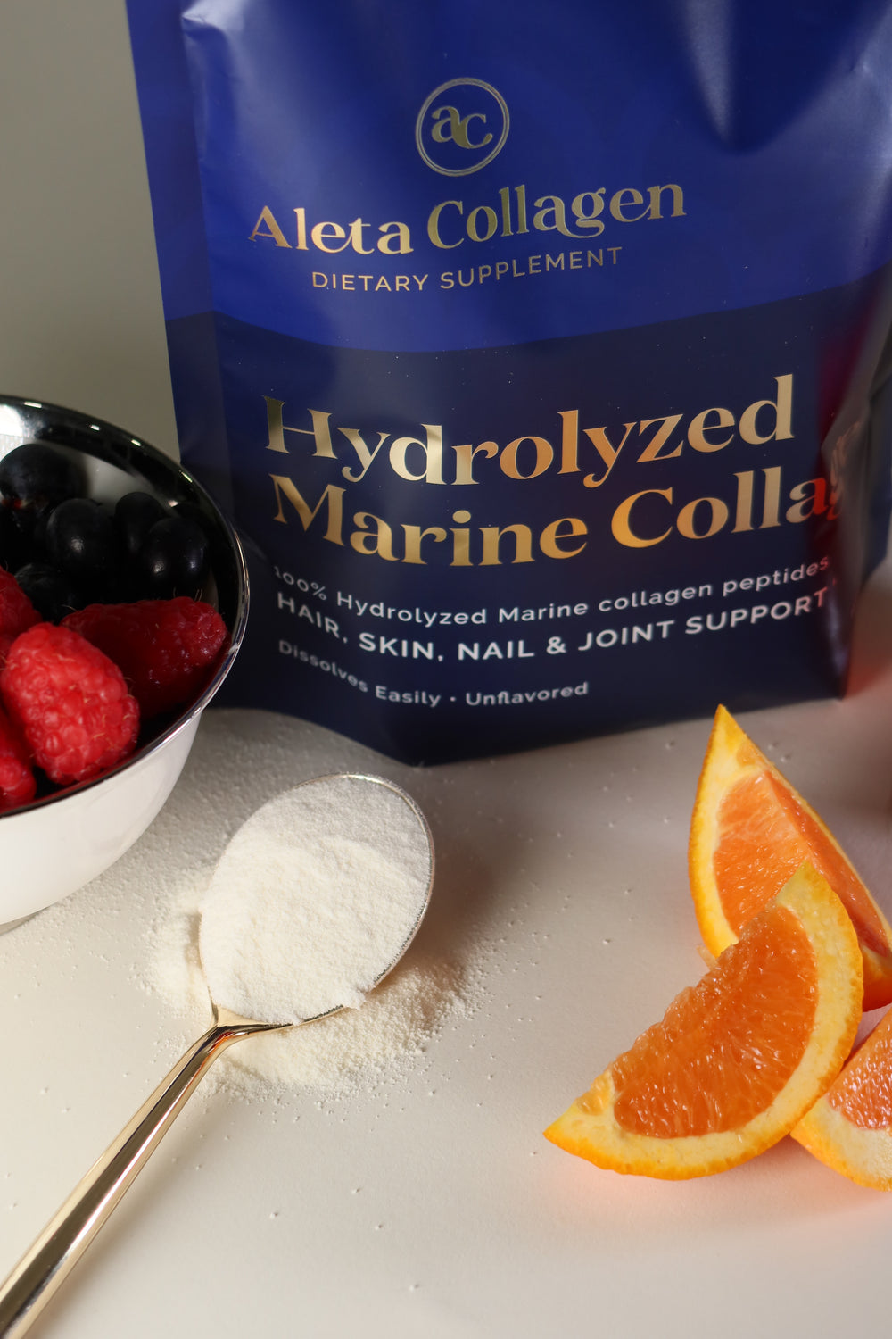 Aleva Collagen hydrolyzed marine collagen supplement with a spoonful of powder and orange slices.